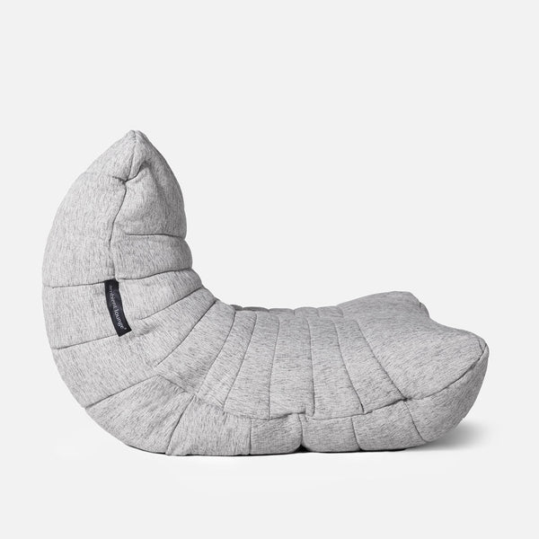 En moderne, lysegrå Acoustic Lounge-salongstol med quiltet stof og en struktureret finish, halvmåneformet og vist fra siden mod en almindelig hvid baggrund.